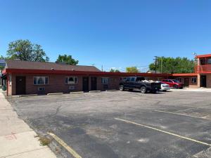 a parking lot with a truck parked in front of a building at Hotel O Englewood-South Denver CO in Englewood