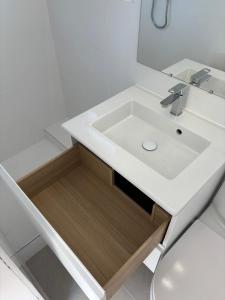 a bathroom with a white sink and a mirror at Appartement T3 - Plage à 500m in Saint-Nazaire