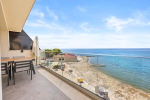 a balcony with a view of the ocean at Calypso Residence 3 in Umag
