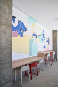 a wall mural in a room with tables and chairs at Moebius - Habitaciones privadas con baño in León