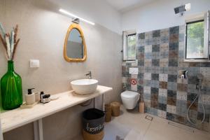 a bathroom with a sink and a toilet at KATINA COTTAGE in Kontogiannátika +45 photos