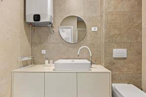 a bathroom with a white sink and a mirror at Calypso Residence 3 in Umag +51 photos