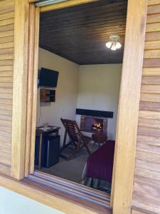 a view from a window of a room with a fireplace at Hospedagem Fernandes Cunha, SP in Cunha +14 photos