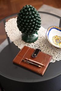 a table topped with a glass table with a phone and a wallet at Teddy House Ortigia in Syracuse
