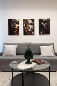 a living room with a couch and a table at Teddy House Ortigia in Syracuse
