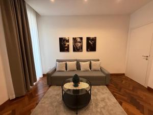 a living room with a couch and a table at Teddy House Ortigia in Syracuse