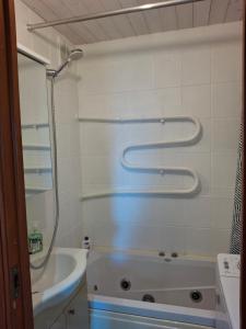 a bathroom with a shower and a tub and a sink at Kalda tee 12 Apartment in Tartu