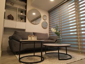 a living room with a couch and two tables at Departamento Costa Playas de Tijuana in Tijuana +12 photos