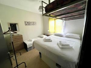 a bedroom with a large bed with towels on it at Cottage near the sea in Nea Moudania