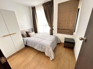 a bedroom with a bed and a window at Centrio 2 bed rooms in Ban Nong Chaeng +6 photos