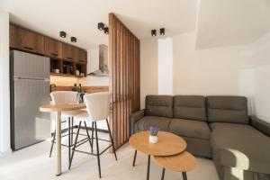 a living room with a couch and a table at Must in in Neos Marmaras