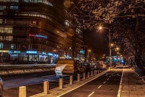 a city street at night with cars parked at Luxury Apartments Burgas in Burgas City