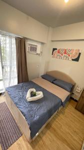 a bedroom with two beds with towels on top of it at Condominium Luxury 1 bedroom, impressive amenities in Davao City