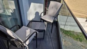 a couple of chairs sitting on a balcony at Cozy Studio Sulina in Sulina
