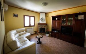 a living room with a couch and a fireplace at Attico in Cefalù
