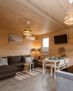 a living room with a couch and a table at Rafa Międzywodzie in Międzywodzie