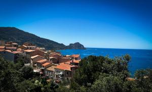 a group of houses on a hill next to the ocean at Attico in Cefalù