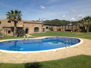 een groot zwembad voor een gebouw bij Hotel Mas Palou in Roses