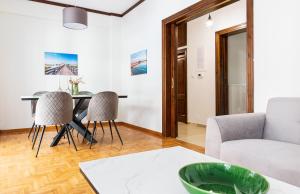 a living room with a table and chairs and a couch at Cozy spacious home in Xanthi in Xanthi