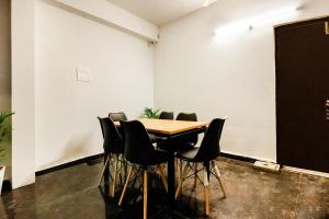 a conference room with a wooden table and chairs at Hotel O GACHIBOWLI BESIDE DLF in Hyderabad