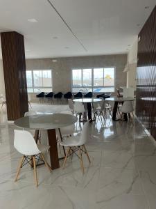 a group of tables and chairs in a room at Condomínio Club Resort 2 quartos com ar na melhor da Aruana in Aracaju +74 photos