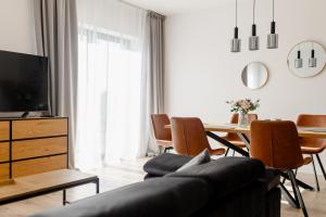 a living room with a couch and a table at Baltic Harmony Villas - Grzybowo in Grzybowo