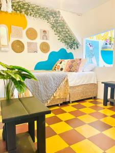 a bedroom with a bed and a checkered floor at Apto cerca al parque de Jardín in Jardin