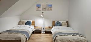 a room with two beds in a attic at Baltic Harmony Villas - Grzybowo in Grzybowo +59 photos