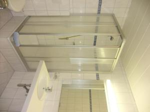 a white bathroom with a toilet and a sink at Hotel Garni Elfriede inklusive Super Sommer Card in Serfaus +8 photos