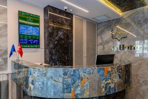 an office lobby with a large marble counter at Felix Hotel in Istanbul
