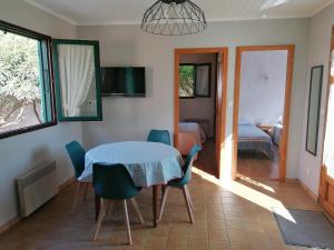 a dining room with a table and chairs and a bedroom at Maison La Belle Lorraine in Valras-Plage