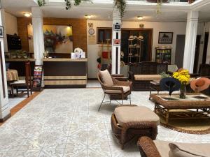 a store with chairs and tables in a lobby at Aleros Hotel Boutique in Cuenca