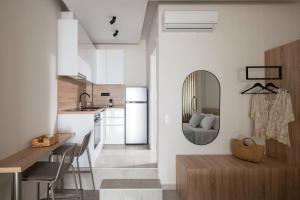 a kitchen and living room with a table and a mirror at Voutia in Kalives Poligirou