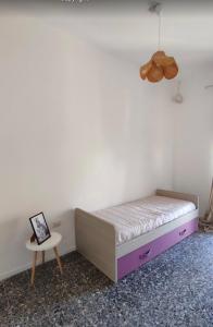 Postel nebo postele na pokoji v ubytování Casa in centro Iglesias il tetto dei nonni Onorat0