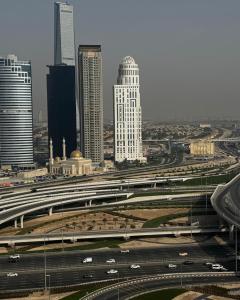 a city with a highway in front of some buildings at TGB Compact Home JBR Marina Manchester Tower in Dubai +2 photos