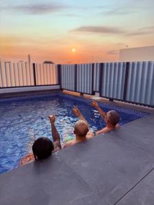 three men in a swimming pool with their arms up at Casa Bella in Dolores