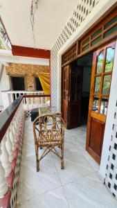 a wicker chair sitting on the porch of a house at De lobos in Calangute