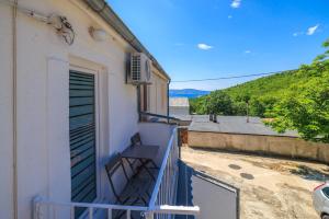 a balcony of a building with a blue railing at Apartment Lozann in Povile