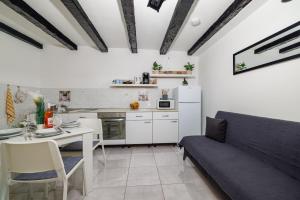 a kitchen with a table and a couch in a room at Apartment Lozann in Povile