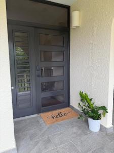 a door with a welcome mat in front of a house at The Beach Loft by Xio in Humacao