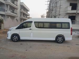 a white van parked in front of a building at سياره اجره in Cairo
