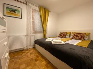 a bedroom with a bed and a window at Karavanke Holiday Getaway in Hrušica