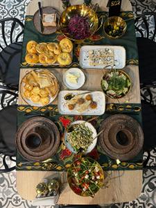 a table topped with lots of food on top at Badyan Boutique Hotel in Bukhara in Bukhara +9 photos