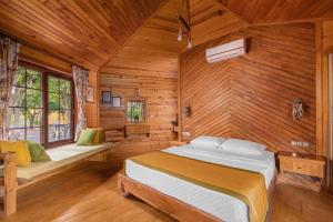 a bedroom with a large bed in a wooden room at Mandarin Bungalow in Alanya +13 photos