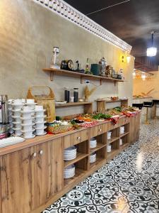 a kitchen with a buffet line with plates and food at Badyan Boutique Hotel in Bukhara in Bukhara