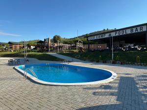 a swimming pool in the middle of a patio at Eco Camp Lake Mladost in Veles