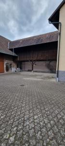 a large building with a brick road in front of it at FeWo JoSa in Kappel-Grafenhausen