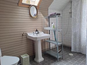 a bathroom with a sink and a mirror and a toilet at Rosendala long stay by House Viola, 3 bedroom entire house in Bodafors, sleeps 7 in Bodafors +25 photos