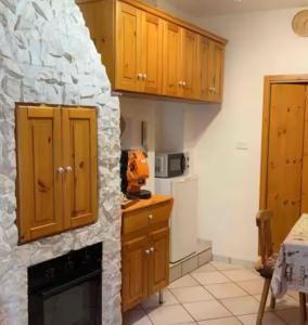 a kitchen with a stone fireplace in a kitchen at Sweet home A&C in Conversano
