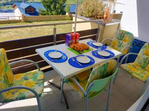 a table and chairs on a balcony with food on it at Pfeiren Leukerbad in Leukerbad